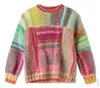 A knitted sweater with a patchwork design in various colors. Produktbild-Vorschau