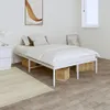 A bedroom scene with a white metal bed frame, white bedding, and two woven storage baskets underneath the bed. A rug is in the foreground, and a piece of art hangs on the wall. Podgląd zdjęcia produktu
