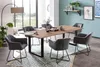 A dining room scene with a wooden table and chairs, set against a large window and a blue wall with artwork. Produktbild-Vorschau