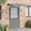 A gray door with a black and transparent awning above it, set against a brick wall. Voir les images du produit