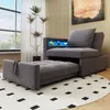 A gray sofa bed is shown in a living room setting, partially pulled out to reveal the bed. Voir les images du produit