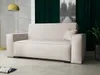 A modern living room setting with a sofa, lamp, and artwork.