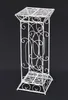 A white metal plant stand against a black background. Náhled obrázku produktu