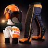 A collection of chainsaw safety gear laid out on a dark surface. Produktbild-Vorschau