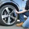 A person is using a can of tire sealant on a car tire. Náhled obrázku produktu