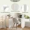A white L-shaped desk with a chair in front of it, set up in a room with a floor lamp and a window in the background. The image also includes close-up details of the desk's construction. Podgląd zdjęcia produktu