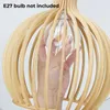 A hand is shown inserting a light bulb into a wooden pendant lamp. Voir les images du produit