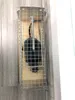 A live trap for rats and mice is shown on a wooden surface against a wall. Produktbild-Vorschau