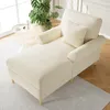 A beige chaise lounge with a pillow in a well-lit room with a plant and a small side table. Náhled obrázku produktu