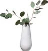 A white vase with a textured pattern holds eucalyptus branches. Produktbild-Vorschau