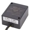 A black electronic power unit with labels indicating input and output specifications. Náhled obrázku produktu