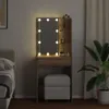 A vanity table with LED lights and a stool in a bedroom setting. Voir les images du produit