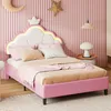 A pink bed with a cloud-shaped headboard and crown detail, decorated with pink and beige bedding, in a child's bedroom with pink fluted walls and celestial decorations. Náhľad obrázku produktu