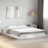 A white bed frame with a mattress and bedding in a bedroom setting. Náhled obrázku produktu