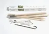 A set of wooden hammock stand components and accessories laid out on a white background, with the product's packaging box visible in the upper portion of the image. Podgląd zdjęcia produktu