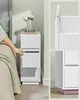 A person's hand is shown opening a drawer on a white nightstand next to a bed. Close-up views of the nightstand are also provided. Náhled obrázku produktu
