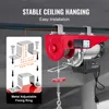 An electric hoist is shown mounted on a ceiling beam, with an inset diagram illustrating its fixing ring and dimensions. Voir les images du produit