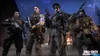 Four soldiers stand in front of a burning building at night. Produktbild-Vorschau