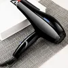 A black hairdryer is placed on a textured gray mat, with a white box in the background. Produktbild-Vorschau