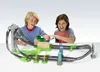 Two boys playing with a Hot Wheels Mario Kart race track. Produktbild-Vorschau