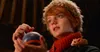 A young boy with red hair and a fluffy hat holds a blue and orange ball, with a small mouse on his shoulder. Náhľad obrázku produktu
