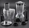 A collection of food processor and blender attachments laid out on a dark gray surface. Produktbild-Vorschau