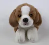 A stuffed beagle puppy lying down against a white background. Produktbild-Vorschau