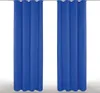Two blue curtains hanging from a rod against a white background.