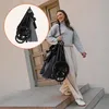 A woman walks down stairs carrying a folded stroller. Náhled obrázku produktu