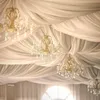 A decorated ceiling with draped fabric and chandeliers. Podgląd zdjęcia produktu