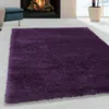 A plush purple rug is laid out on a light-colored floor in front of a fireplace. Anteprima dell’immagine prodotto