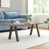 A coffee table with a vase of flowers and a cup of coffee on it, placed in a living room setting with a blue sofa and a window in the background. Podgląd zdjęcia produktu