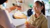 A person is pouring a smoothie from a blender into a glass for a child. Náhľad obrázku produktu