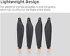 Four black drone propellers with orange tips are displayed against a light gray background, with text describing their lightweight design. Náhľad obrázku produktu