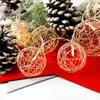 Christmas-themed decoration with pine cones and string lights. Náhľad obrázku produktu