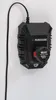 A black Parkside battery charger is mounted on a white wall. Náhled obrázku produktu