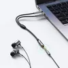 A laptop with an audio splitter cable connected, and earphones nearby. Podgląd zdjęcia produktu
