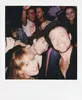 A group of young adults taking a selfie at a party or event. Produktbild-Vorschau