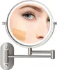 A close-up of a woman's face with foundation swatches being tested on her cheek, reflected in a lighted makeup mirror mounted on a wall. Produktbild-Vorschau