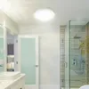 A modern bathroom with a shower and sink. Náhled obrázku produktu