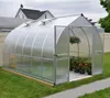 A greenhouse with plants inside, set up in a backyard. Podgląd zdjęcia produktu