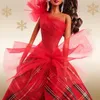 Close-up of a Barbie doll wearing a festive red dress with plaid accents and tulle overlay. Náhľad obrázku produktu