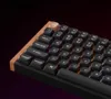 A close-up shot of a black mechanical keyboard with a wooden trim, showcasing its keys and RGB backlighting. Voir les images du produit