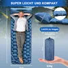 A man is lying on a blue camping mat in a natural outdoor setting. The image also shows the mat folded into a compact bag and includes dimensions and weight. Produktbild-Vorschau