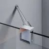 A close-up view of a shower enclosure hinge and track system mounted on a wall and glass panel. Podgląd zdjęcia produktu