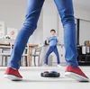 A child and an adult playing with a hover ball in a kitchen. Podgląd zdjęcia produktu
