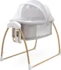 A baby bassinet with a canopy and a mobile. Podgląd zdjęcia produktu