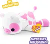 A plush toy cow with pink spots lying on a white background, with marketing text overlays. Produktbild-Vorschau