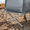 Close-up of the legs and frame of a camping bed on rocky ground. Produktbild-Vorschau