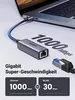 A USB-C to Ethernet adapter connected to a laptop, with text highlighting its gigabit speed. Voir les images du produit